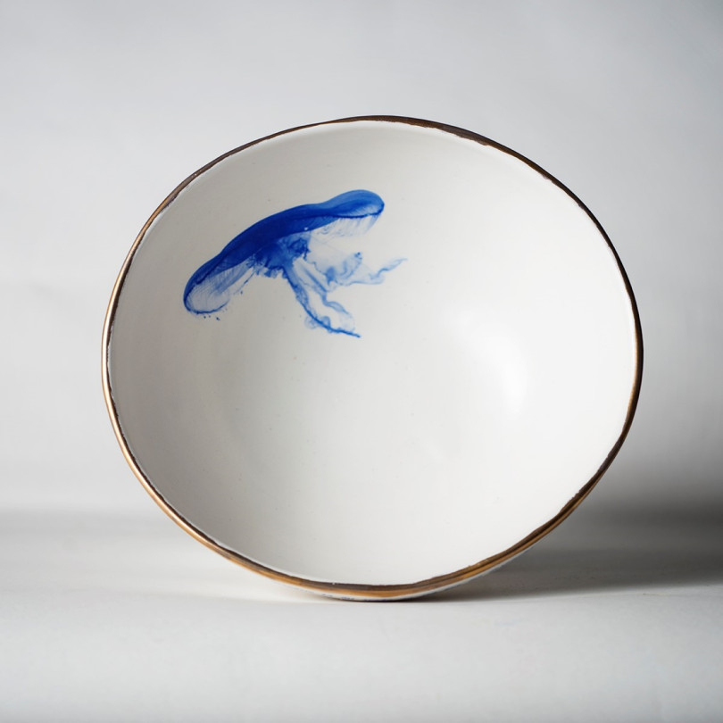 White bowl decorated with a blue jellyfish. Handcrafted ceramic from Barcelona